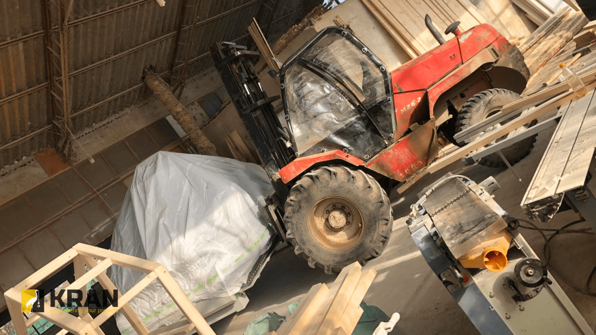 Transporting a machine using an all-terrain forklift rental