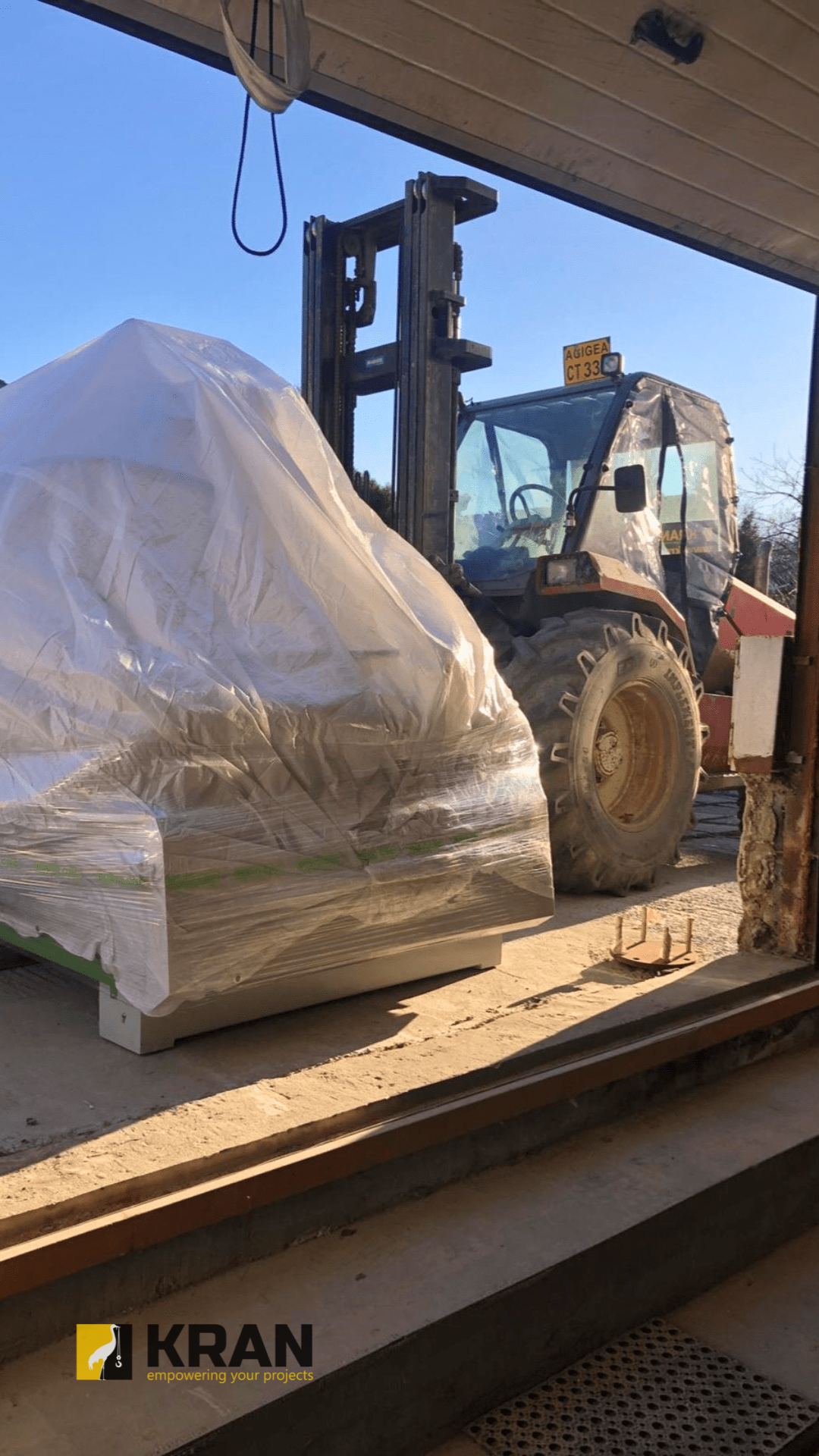 Transporting a machine using an all-terrain forklift rental